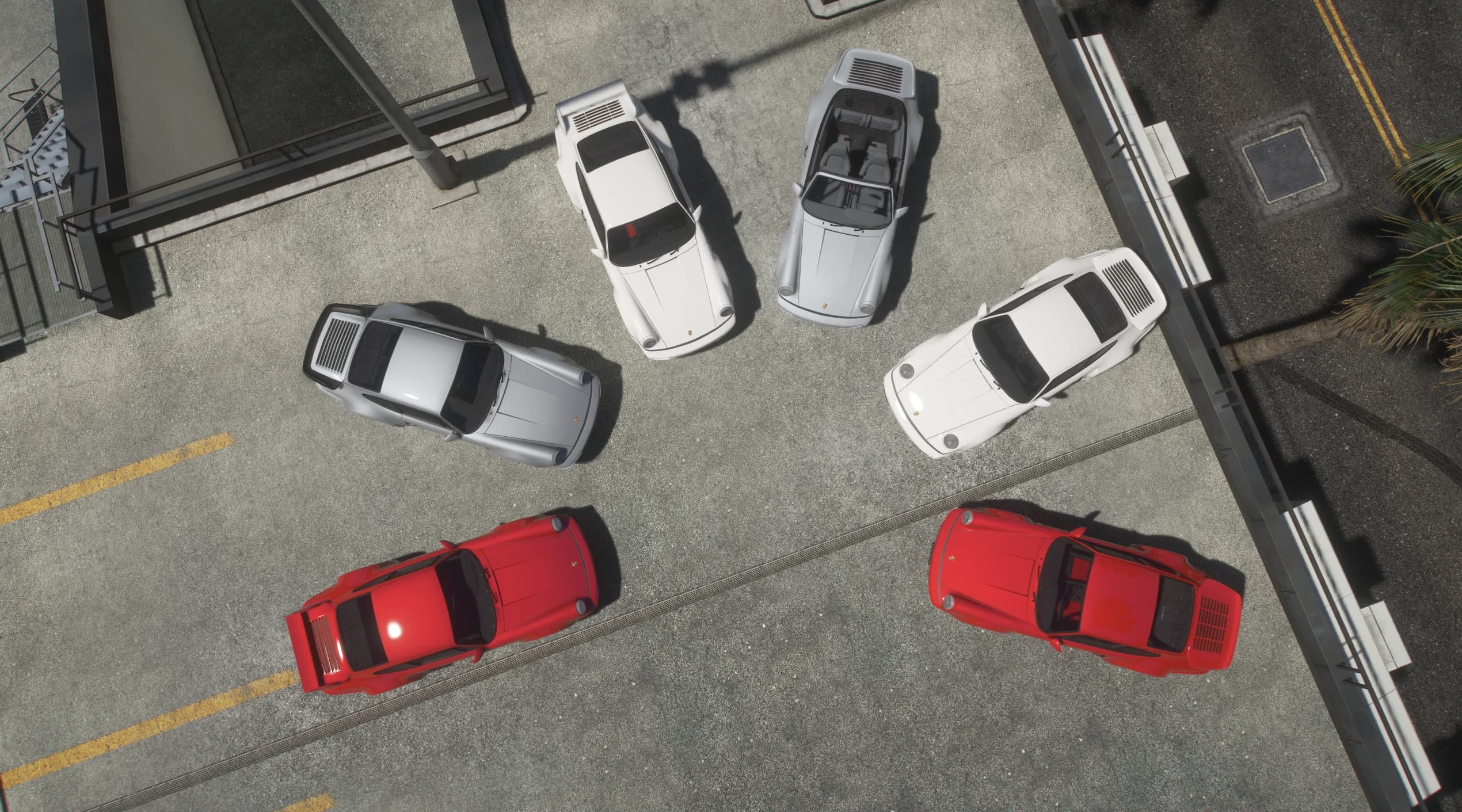 Vista cenital de los seis 964 en un aparcamiento, desde el Speedster abierto con los asientos a la vista hasta los Turbo de carrocería ancha y alerón de cola de ballena en rojo y blanco