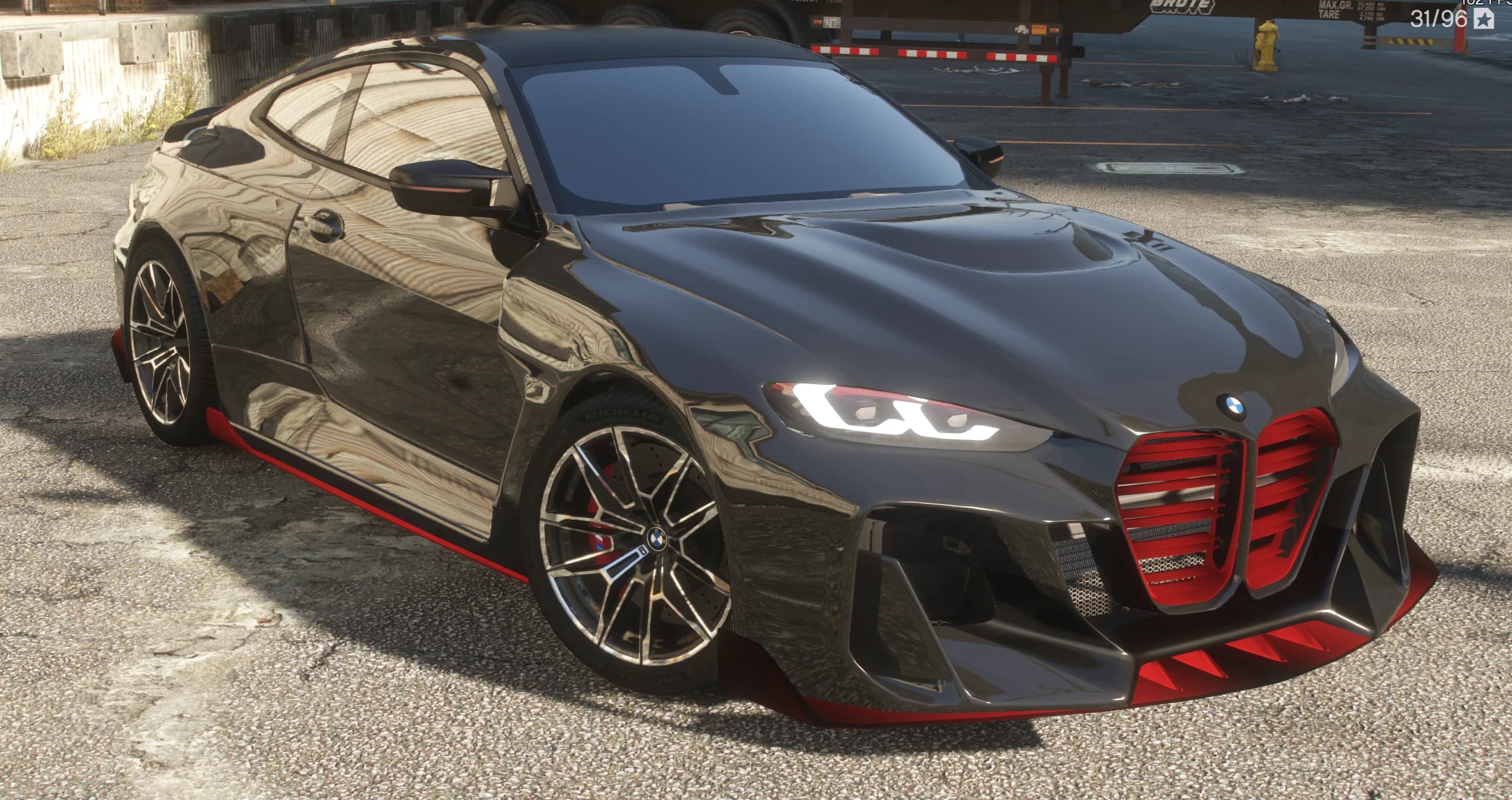 Vista frontal en tres cuartos del M4 widebody negro con las parrillas de riñón pintadas de rojo, aletas rojas en el splitter y llantas M sobre pinzas rojas con las franjas M