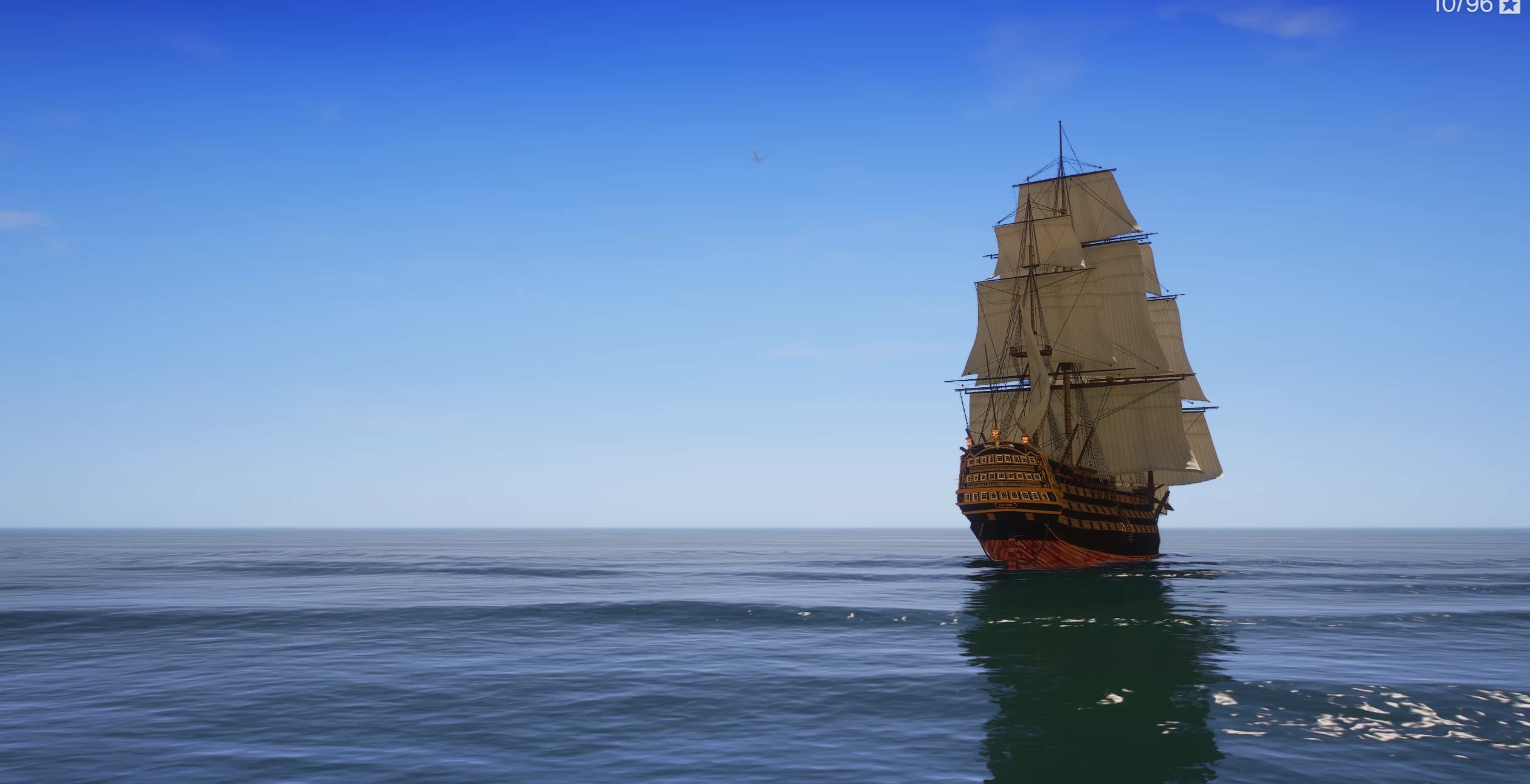 El HMS Victory navegando en mar abierto bajo un cielo despejado, visto desde lejos