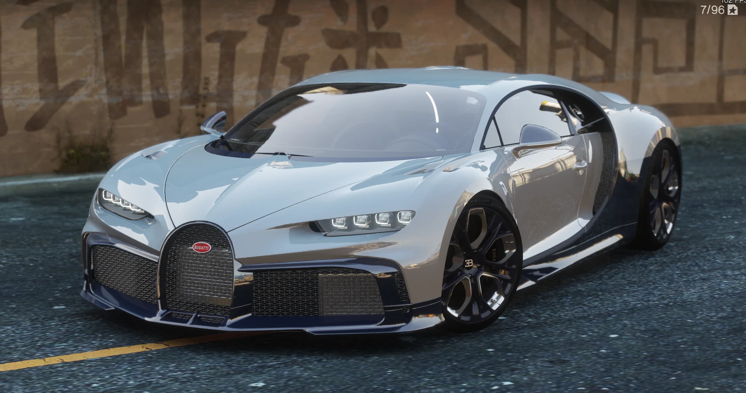 Vista frontal cercana del Chiron Profilee con el splitter delantero de carbono, los dos grupos ópticos LED de cuatro elementos y las llantas doradas y negras