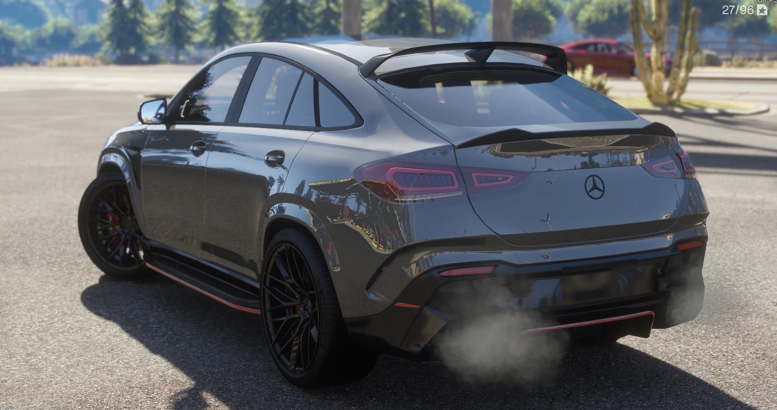 Tres cuartos trasero del GLE con la caída de techo coupé, el alerón de techo y el labio del portón, la estrella en el portón, los pilotos LED y el humo del escape sobre el difusor con perfil rojo