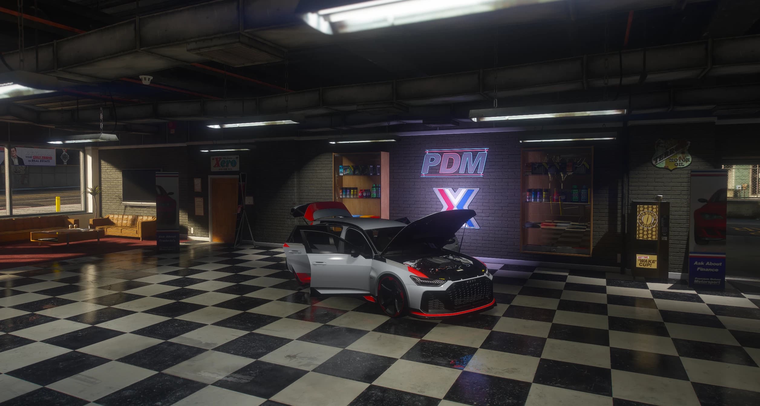 Vista amplia del concesionario Premium Deluxe Motorsport con el RS6 GT aparcado bajo el letrero de neón PDM, con el capó, el portón y la puerta del conductor abiertos y el vano motor a la vista