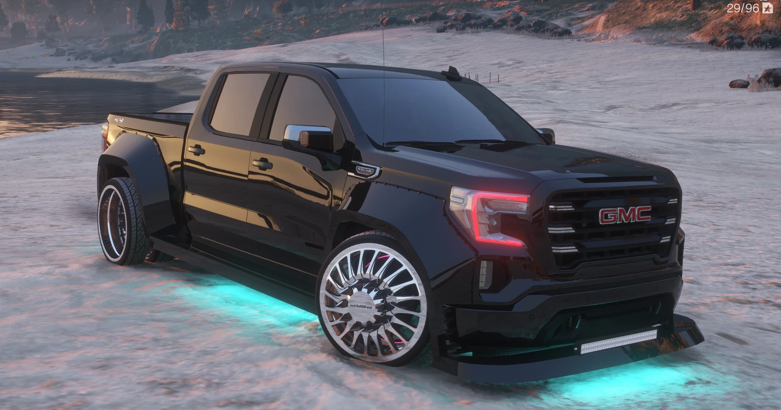 GMC Sierra dually pickup negro widebody y custom, tres cuartos frontal, rebajado sobre llantas dually cromadas multirradio con luz inferior cian, barra de luz en el splitter delantero y la insignia roja de GMC en la parrilla