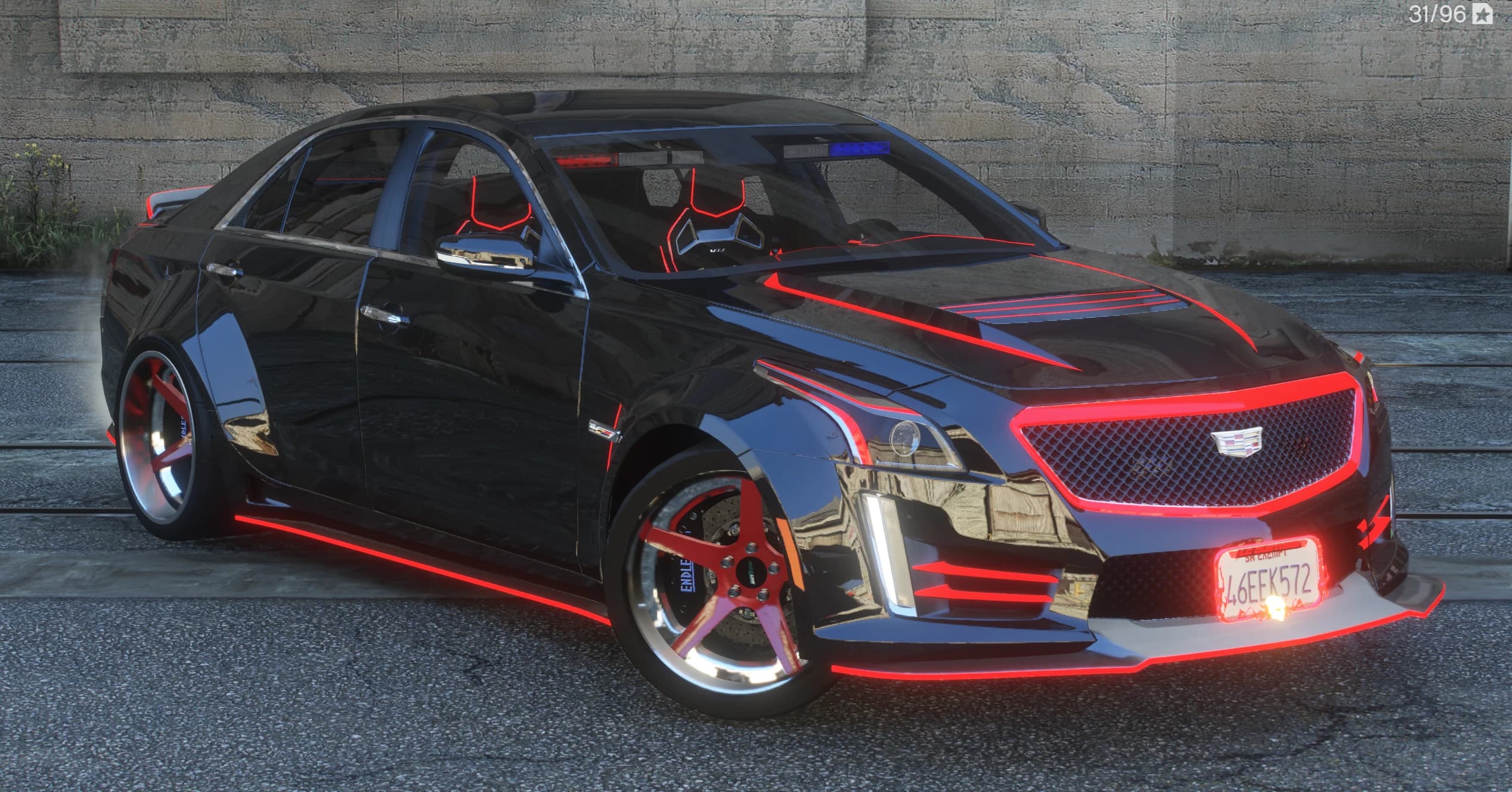 Vista frontal en tres cuartos del CTS-V negro con líneas rojas luminosas en el capó, el marco de la parrilla y las faldillas, y llantas rojas de cinco radios