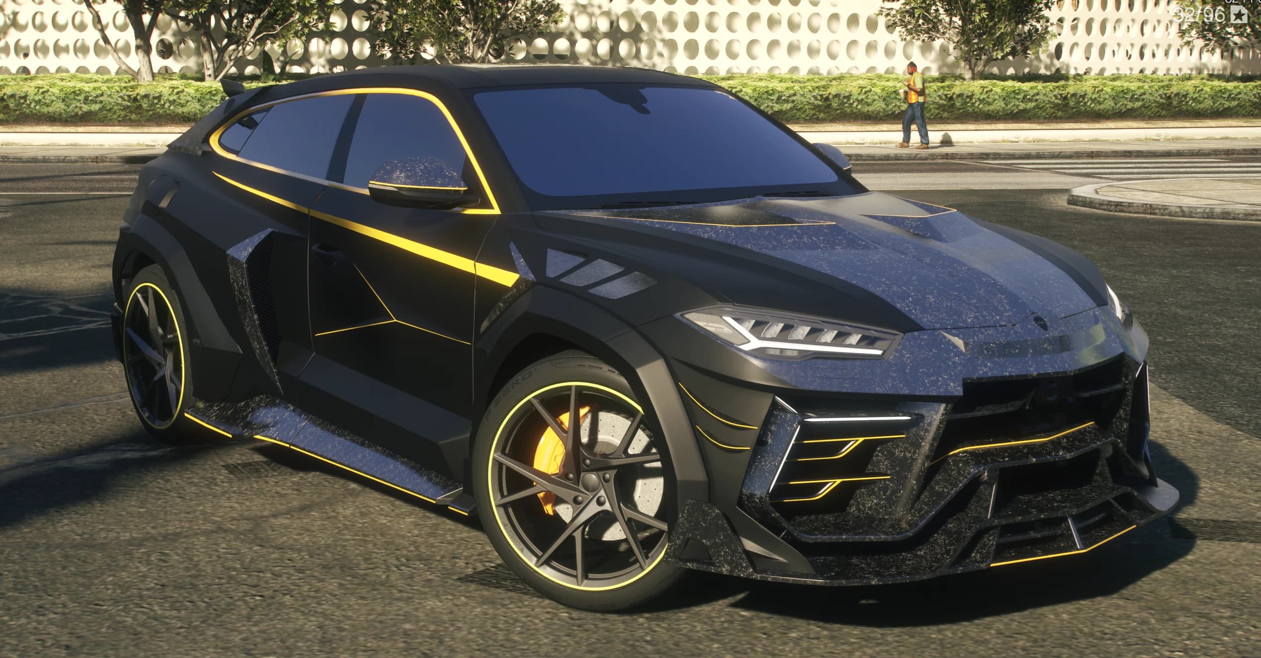Vista frontal en tres cuartos del Urus Mansory negro mate con perfiles amarillos, canards de carbono y pinzas amarillas