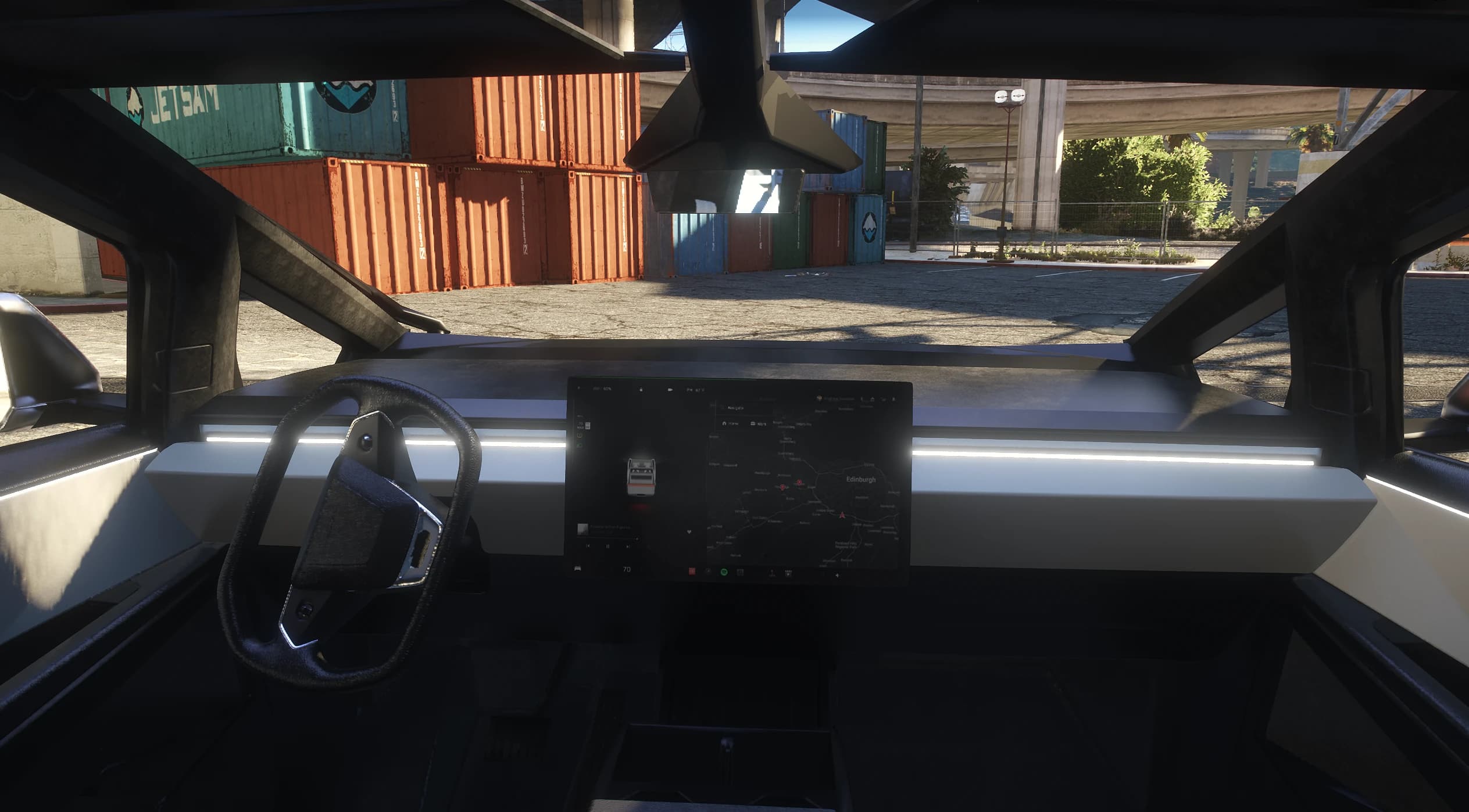 Interior del Cybertruck en primera persona con el volante yugo y la gran pantalla táctil horizontal