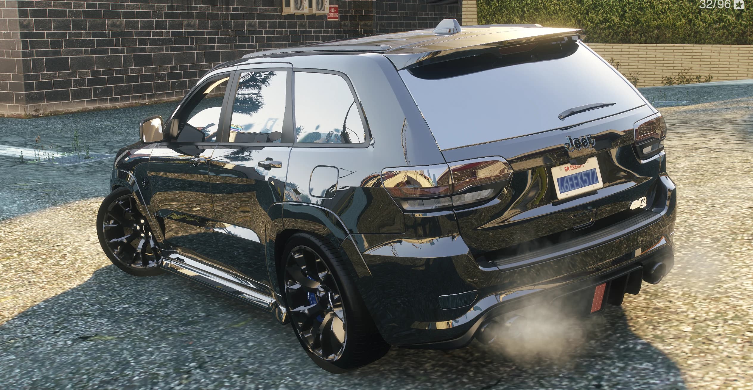 Vista trasera del Grand Cherokee con pilotos tintados, el emblema Jeep y humo saliendo de los escapes del difusor
