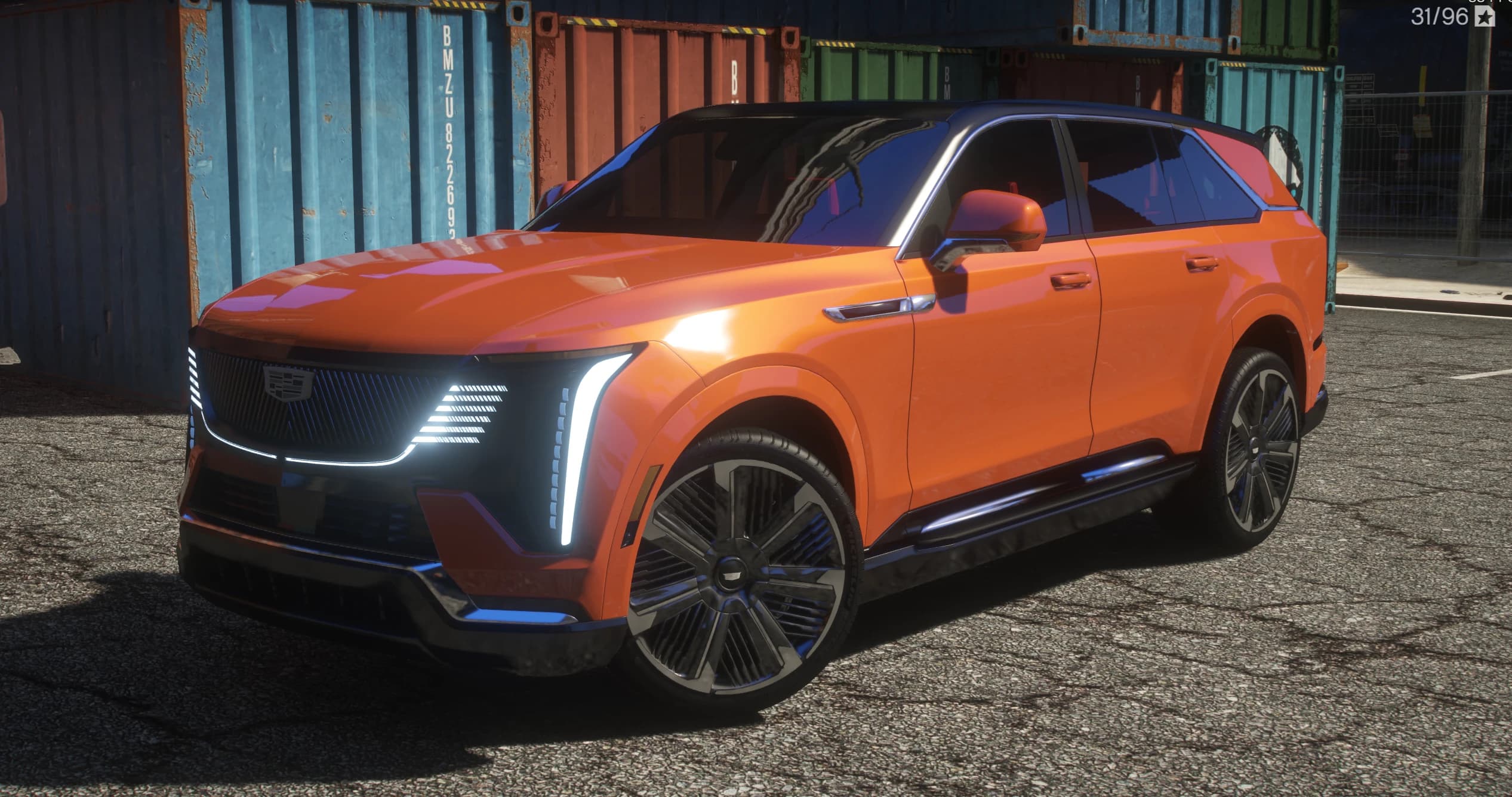 Vista frontal en tres cuartos del Escalade IQ naranja con la parrilla iluminada, las cuchillas LED verticales y el techo negro