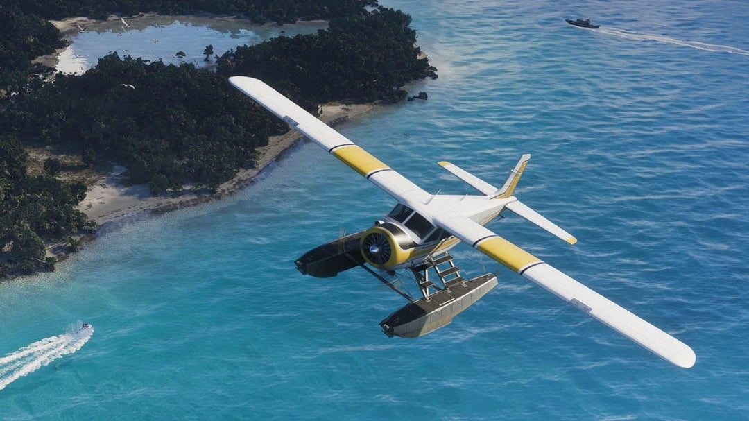 A single engine seaplane on floats banking low over shallow turquoise water, with mangrove islands, a sandbar and two speedboats below